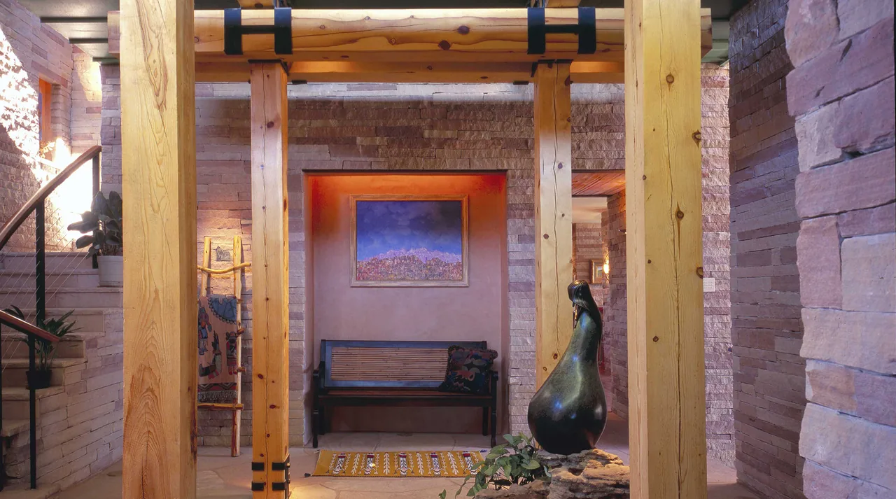 The Greene project features exposed timber beams and stone walls with integrated art and seating.