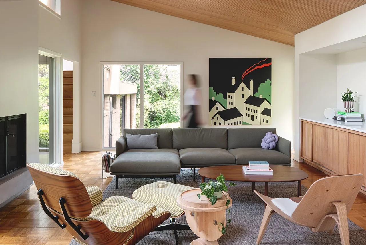 Living room features a gray sectional sofa, wood armchairs, parquet flooring, and a vaulted wood ceiling.