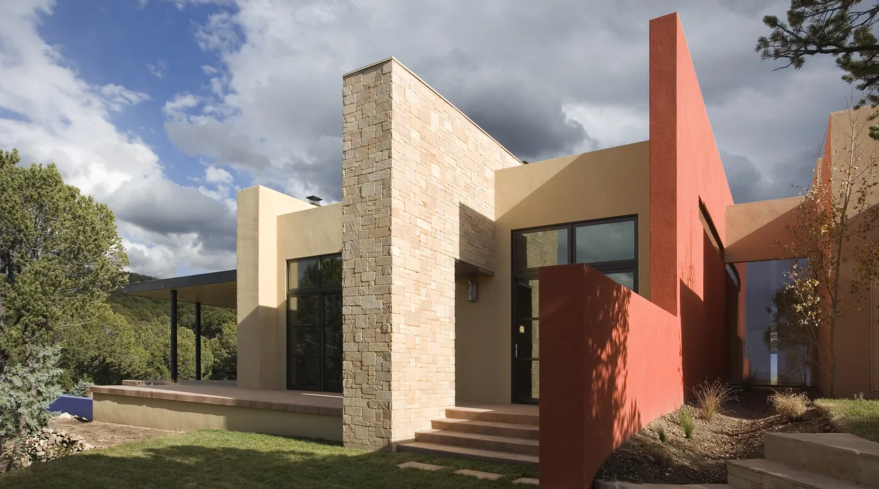 The Lehman project showcases a modern home exterior with stone, stucco, and dark window frames by Archaeo Architects.
