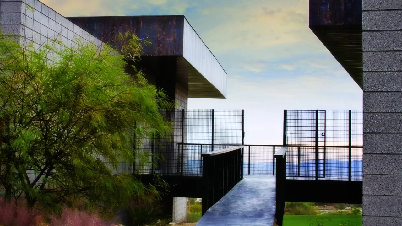 Walkway bridge connects two parts of the HOUSE IN 2 PARTS project by Assemblage Studio.