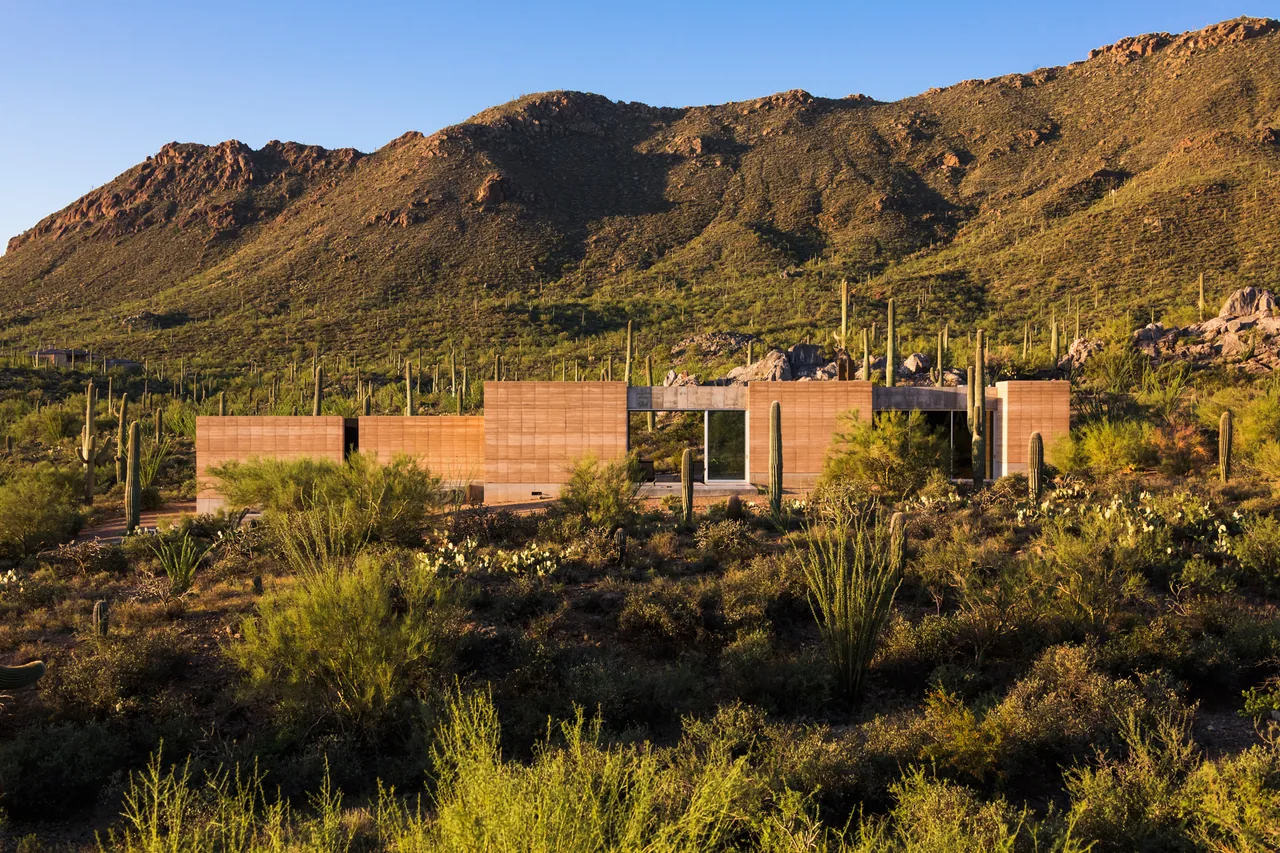Tucson Mountain Retreat by Dust Architects features rammed earth exterior walls blending with desert surroundings in Phoenix.