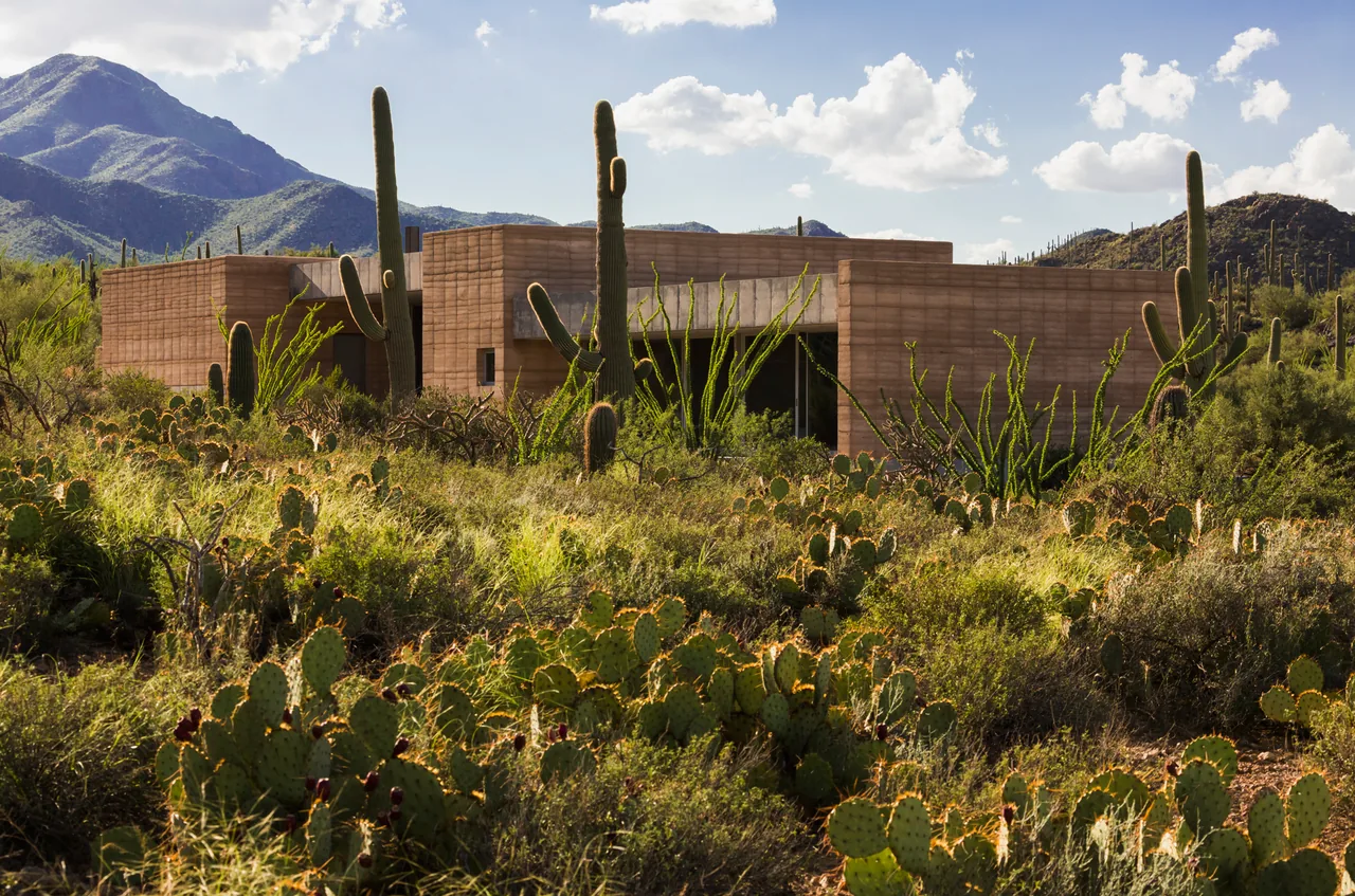 The Tucson Mountain Retreat by Dust Architects features stepped concrete block walls blending into the desert landscape near Phoenix.