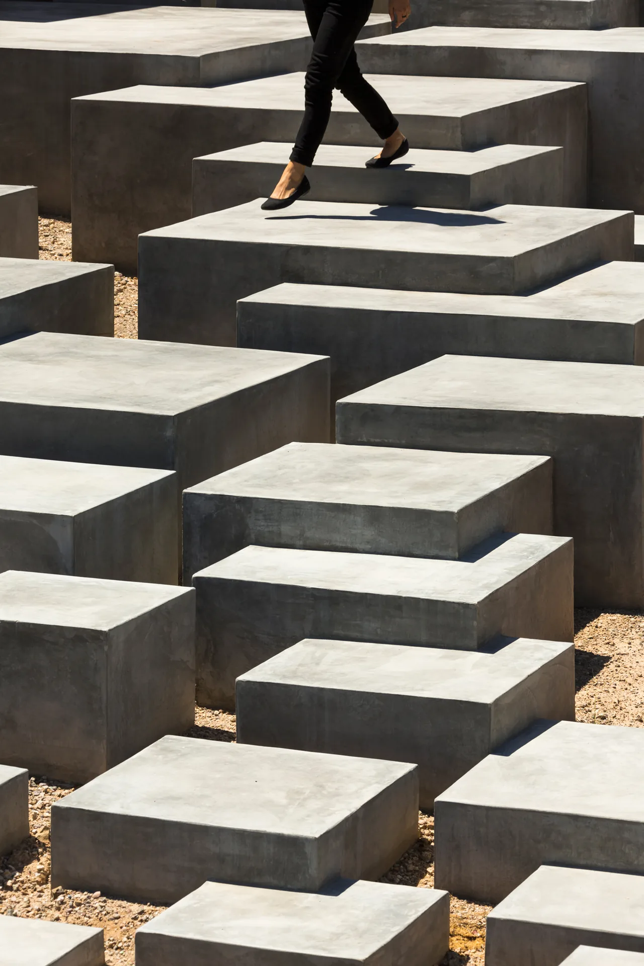 Stepped concrete blocks form a modern outdoor path or seating area at Tucson Mountain Retreat.