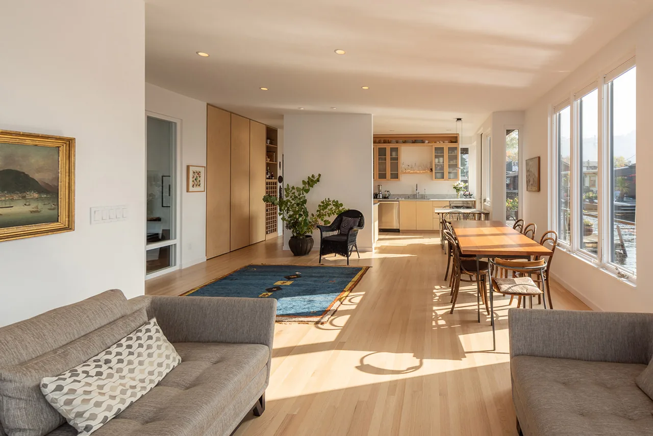 Lake Union Floating Home features bright living and dining spaces with lake views and light wood flooring.