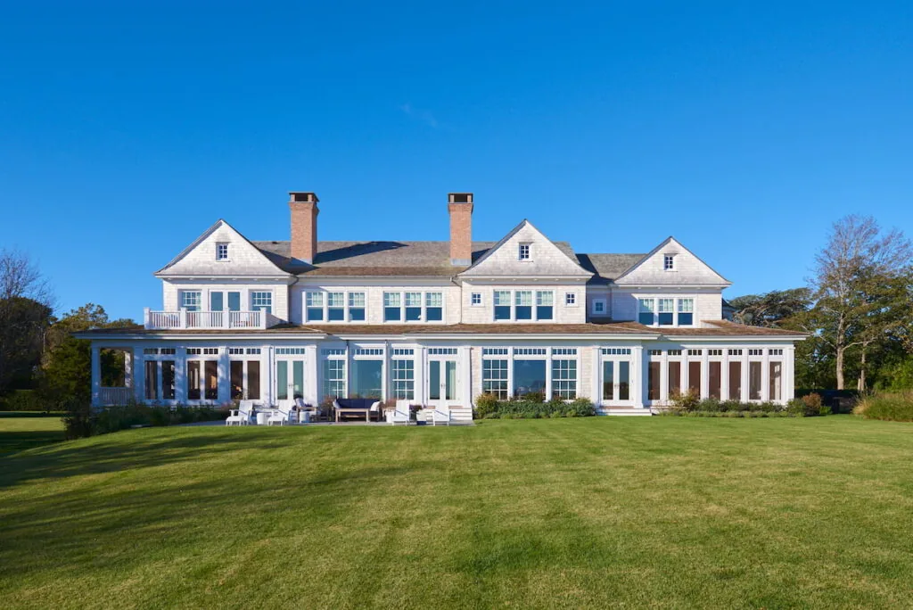Front exterior of American Classic project featuring a wraparound porch and shuttered windows.