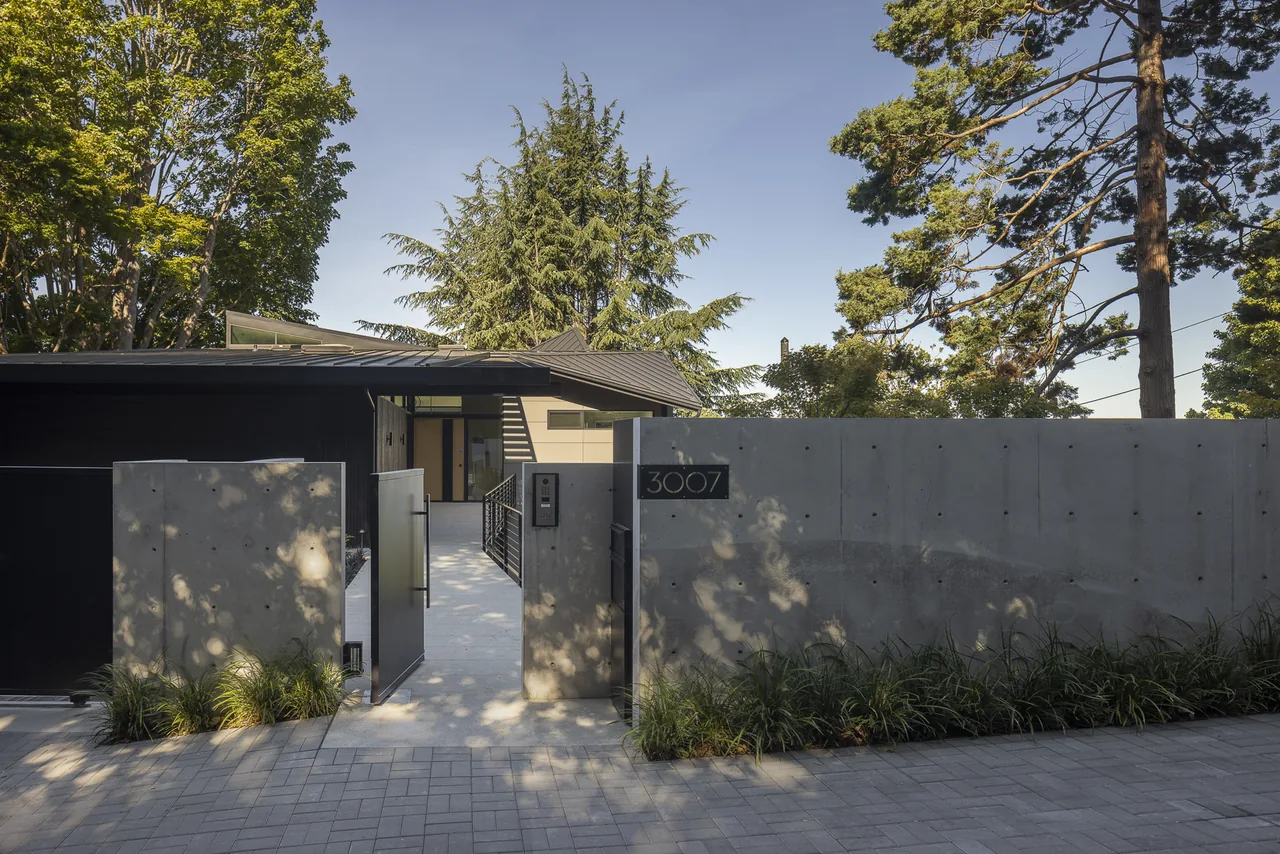 The Perkins Lane project features a modern entrance with clean concrete walls and a metal gate.