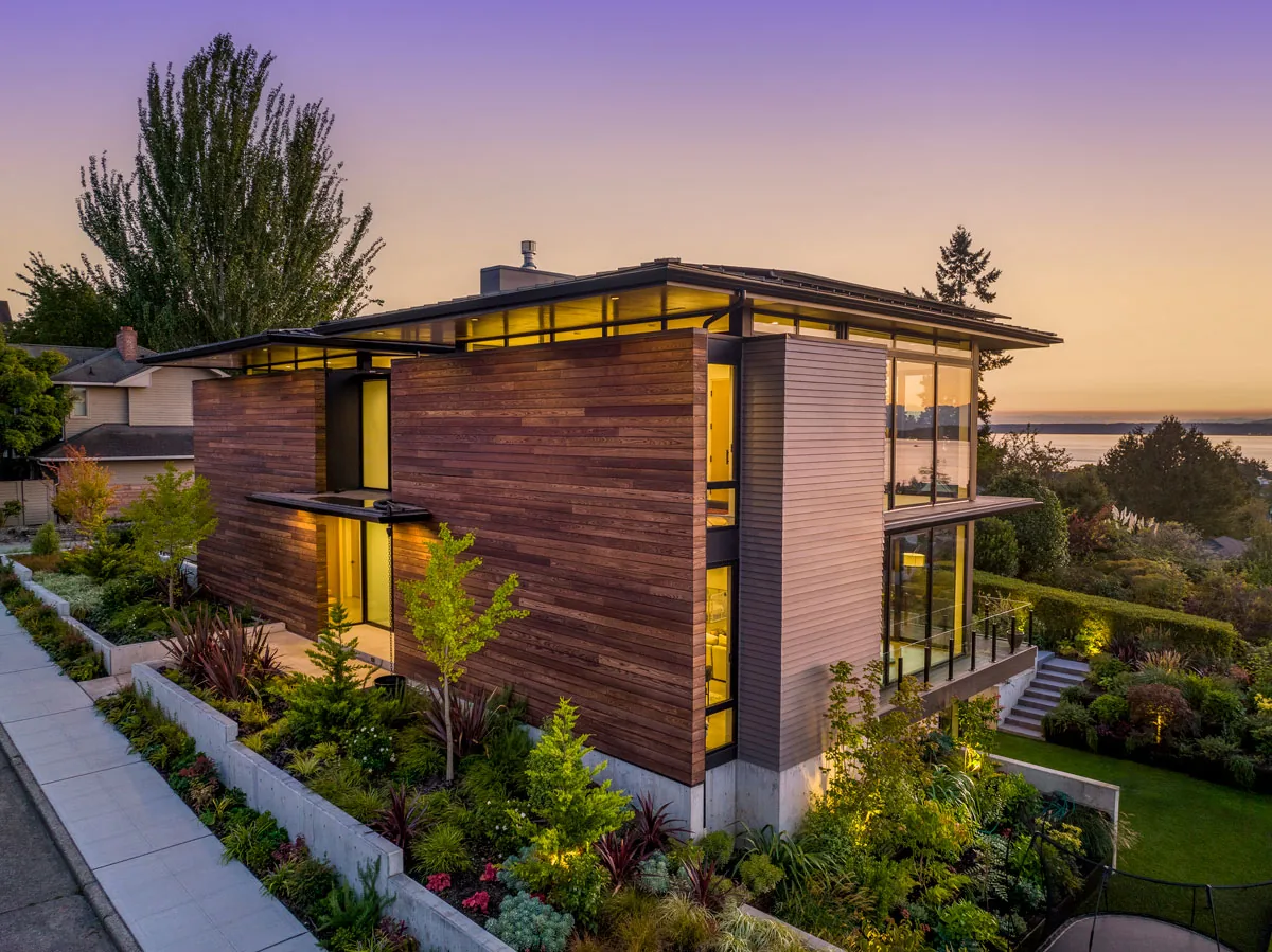 West Seattle House by BC&J Architects features mixed wood siding and extensive glazing for scenic views.