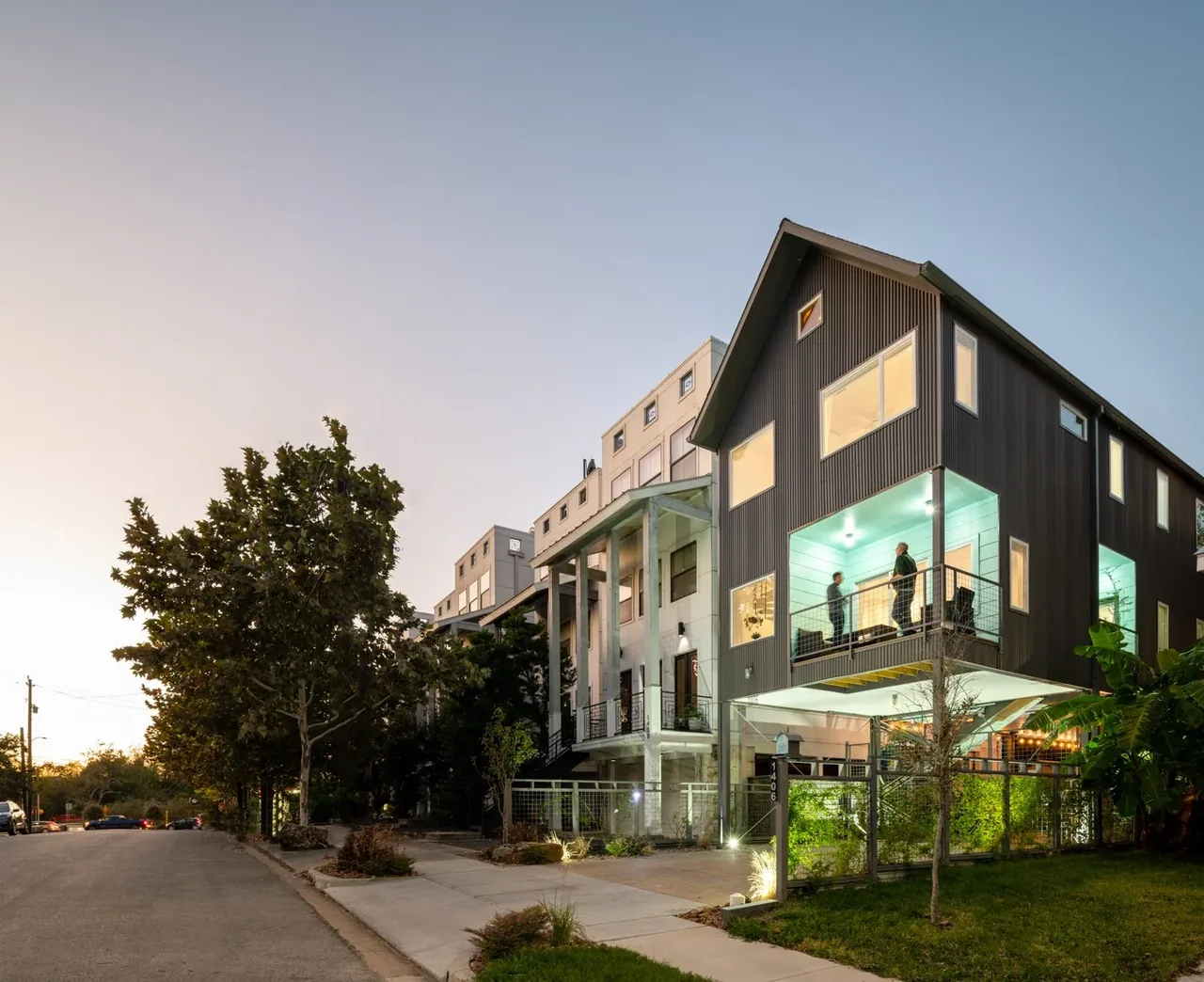 The Saunders House by Brett Zamore Design in Houston features a modern exterior with a raised balcony and extensive glazing.