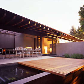 The Fauntleroy project features a pergola-covered outdoor patio with a wooden deck spanning a water feature.
