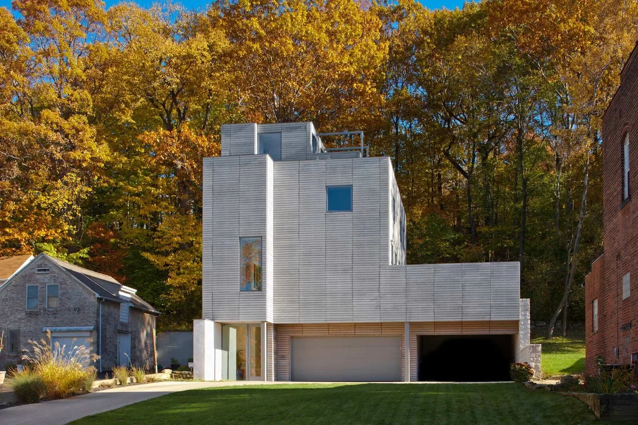 Front exterior of the Fairview Townhouse II featuring horizontal siding and rectangular windows.