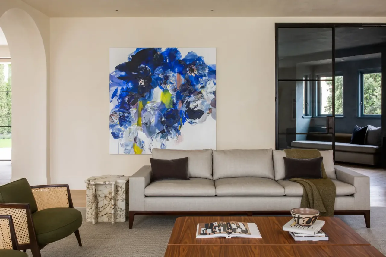 Living room featuring neutral palette, green armchairs, and abstract blue floral painting in Sea Cliff Sculptural project.