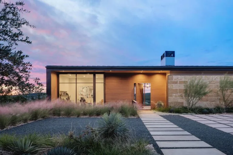 Laceback Terrace exterior front by James D. LaRue Architecture features wood siding and stone walls with a flat roof.