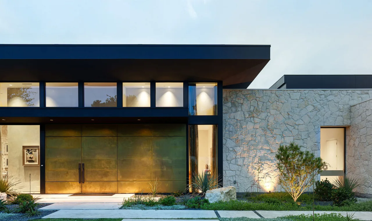 FIVE Austin project features a modern facade with bronze doors, stone cladding, and clerestory windows.