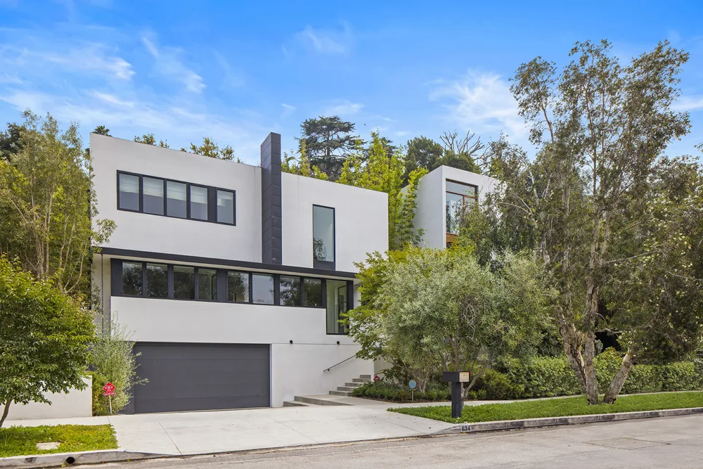 Halo House by Callas Shortridge Architects features clean white stucco walls and black-framed windows in a two-story design.