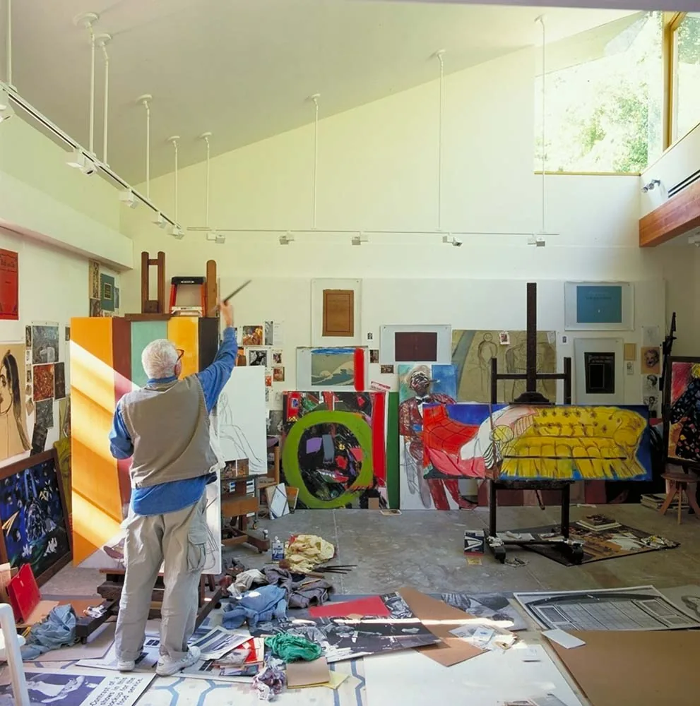 Indoor art studio with high ceiling, sloped roof, and clerestory window providing natural light.