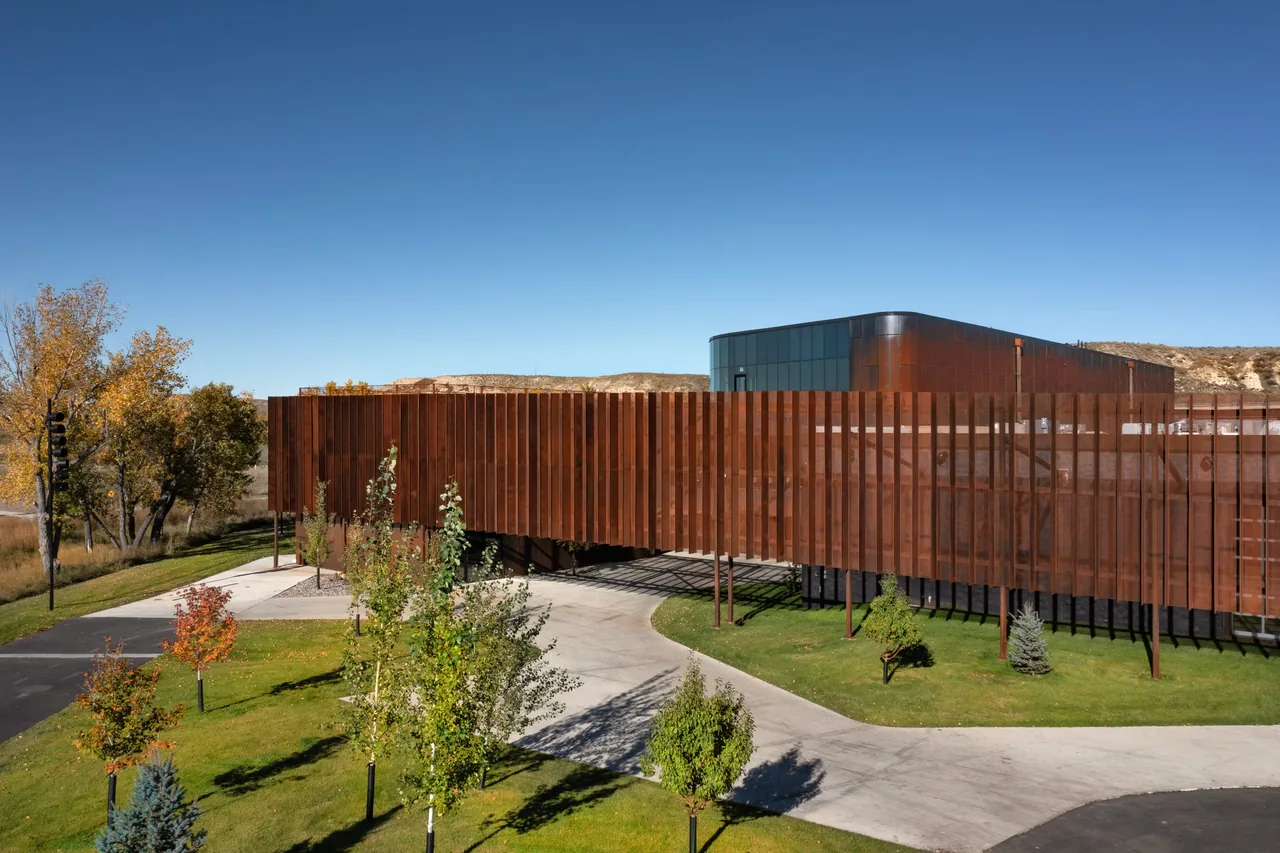 The Skyview project features a modern exterior with vertical rust-colored metal slats and a curved metal upper structure.