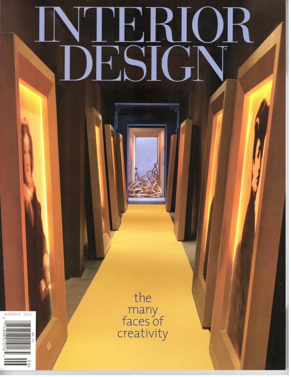A corridor lined with tilted backlit framed portraits and a yellow carpet leading to artistic sculpture at the end.