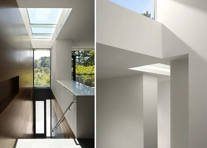 Hill House stairwell features a skylight and wood accent wall that brings natural light into the space in San Francisco.