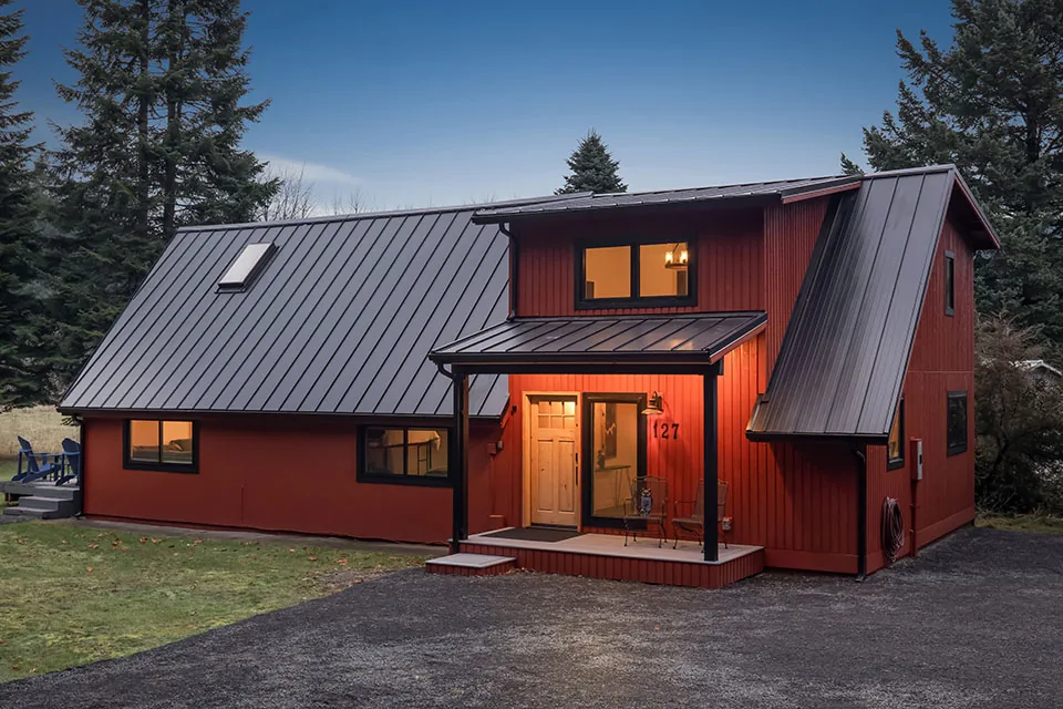 Crescent Beach remodel draft showing a red house with standing seam metal roofs and black window frames by Grouparchitect in Seattle.