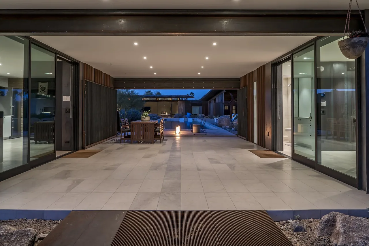 The 4018 casita features a covered patio with recessed lights leading to a rectangular pool and outdoor seating with a fire feature.