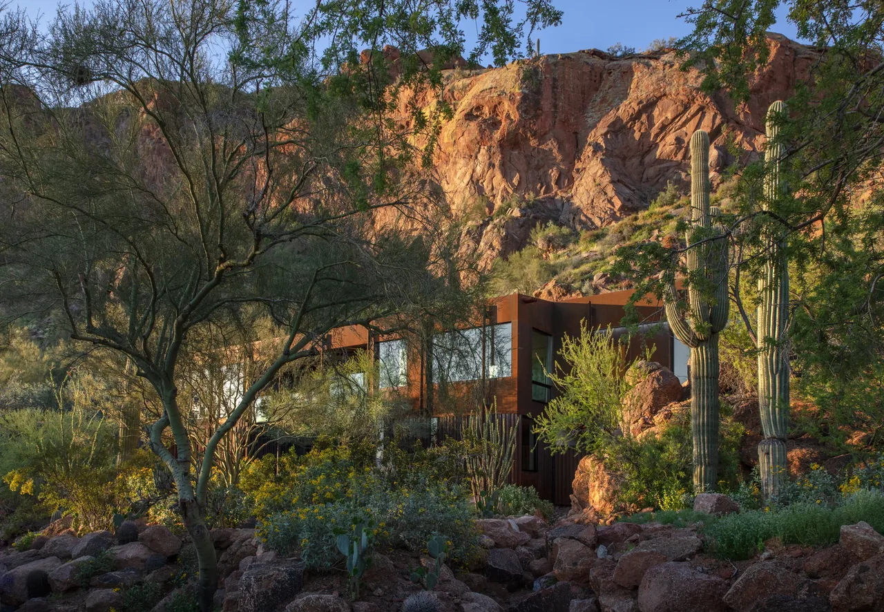 The Cliffback project by The Construction Zone features weathered steel cladding integrating with the desert rock landscape in Phoenix.
