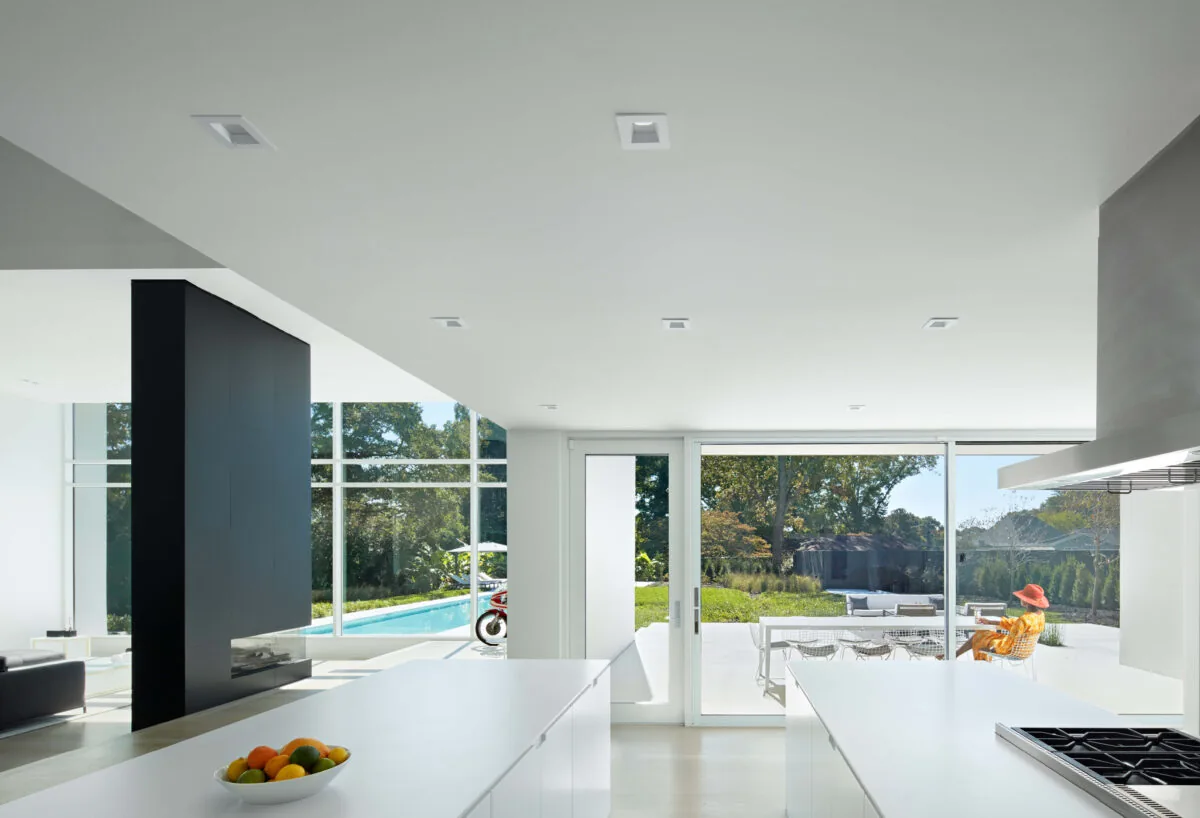 Frame House kitchen and outdoor patio with floor-to-ceiling glazing by Tonic Design & Construction.