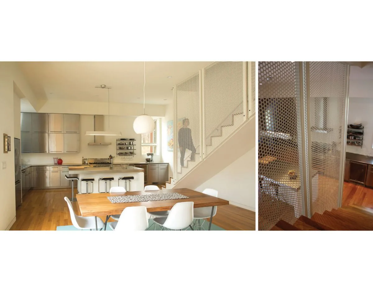 This interior view features a modern kitchen and dining space with wood floors and a metal mesh stair railing.
