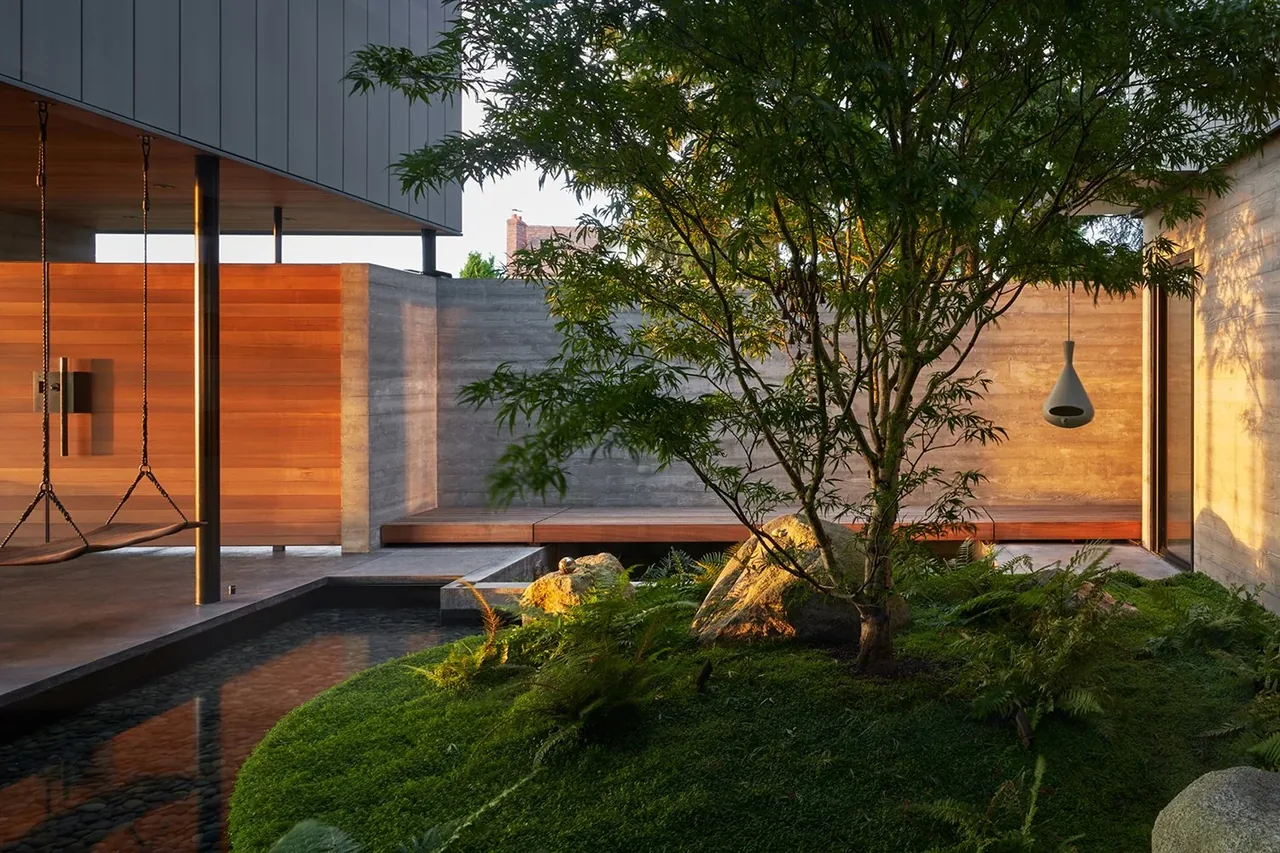 The Perch by Chadbourne + Doss Architects features a tranquil courtyard with a Japanese maple and moss ground cover in Seattle.