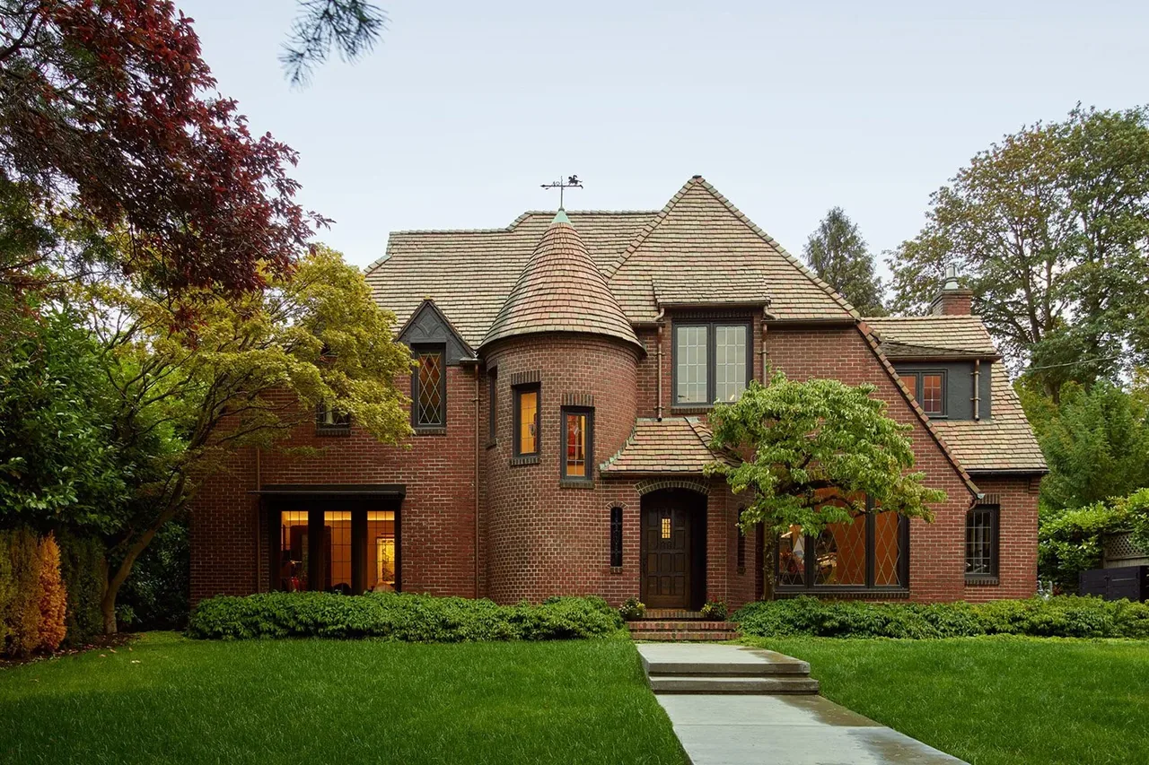 The Past Present House features brick construction with a turret and diamond-lattice windows, designed by Chadbourne + Doss Architects.