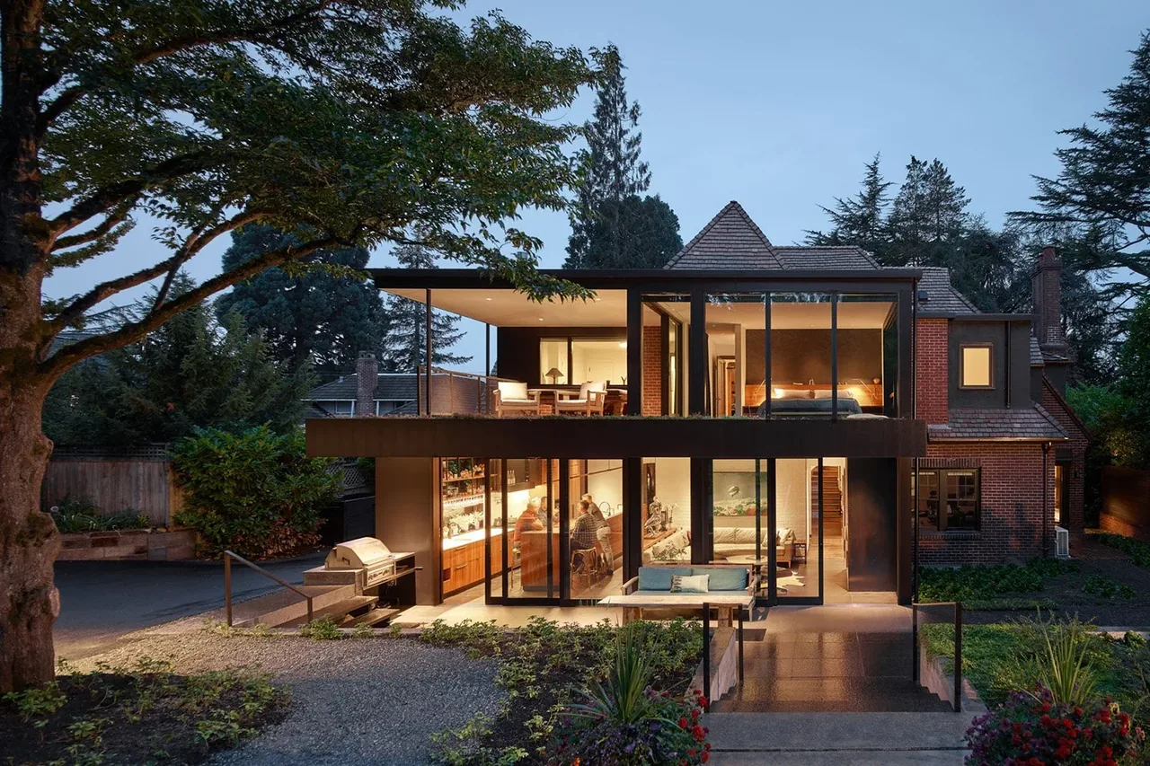 The Past Present House in Seattle blends original brick design with modern glass additions by Chadbourne + Doss Architects.
