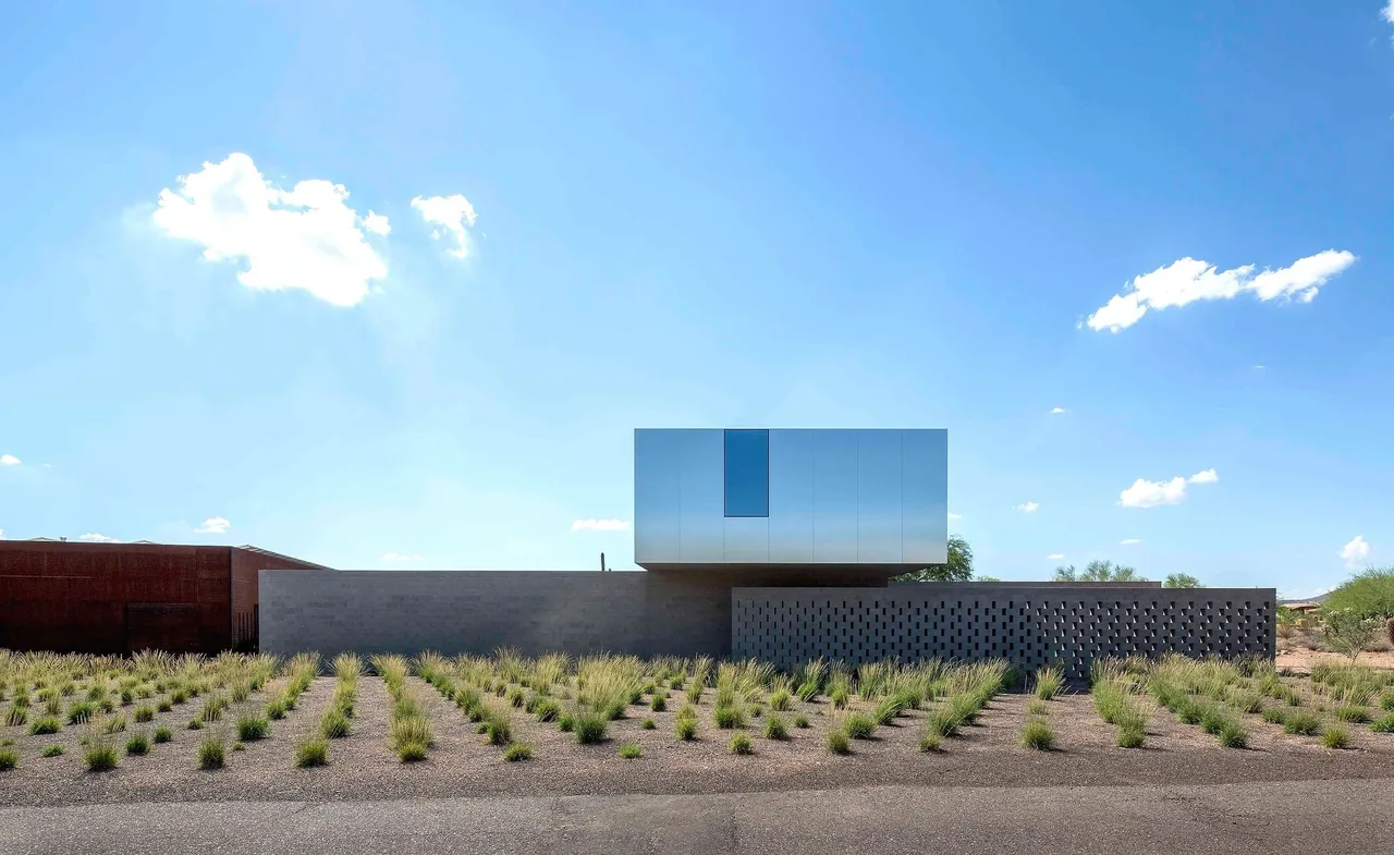 Staab residence features a cantilevered metal upper volume and perforated concrete block wall with desert landscaping in Phoenix.