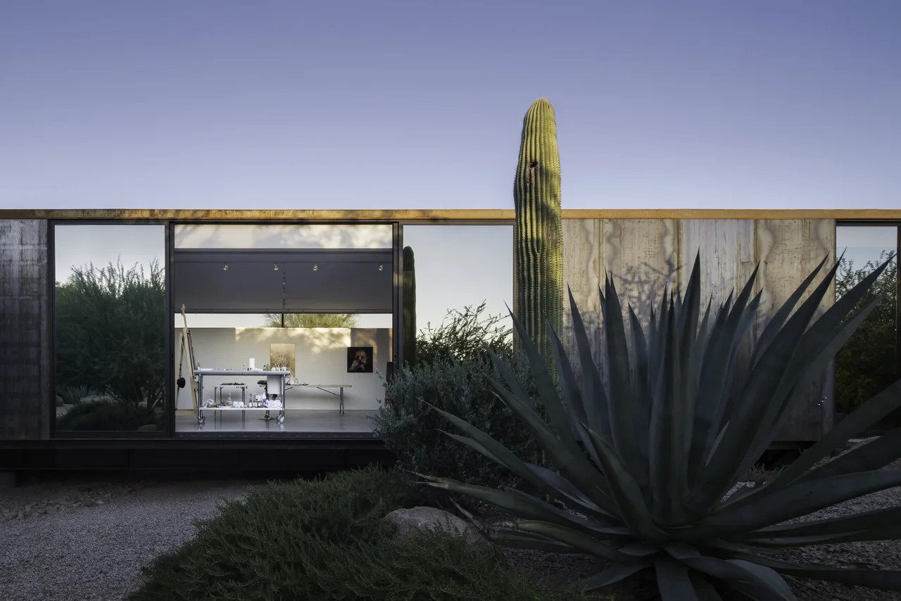 Project six exterior by Chen Suchart Studio features rusted metal siding and floor-to-ceiling glazing.