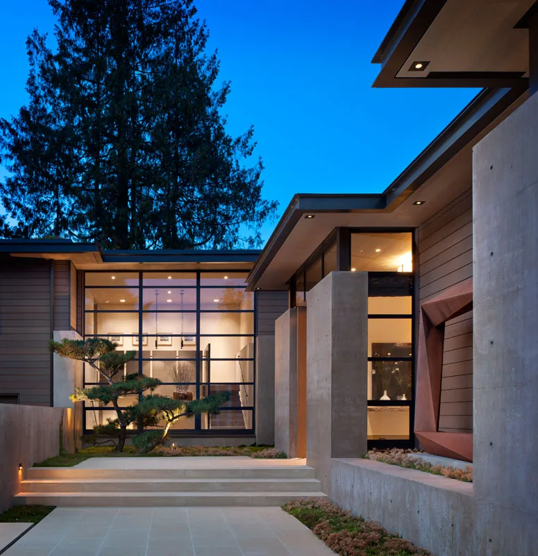Washington Park Residence features large window walls and exposed concrete elements in a modern style.
