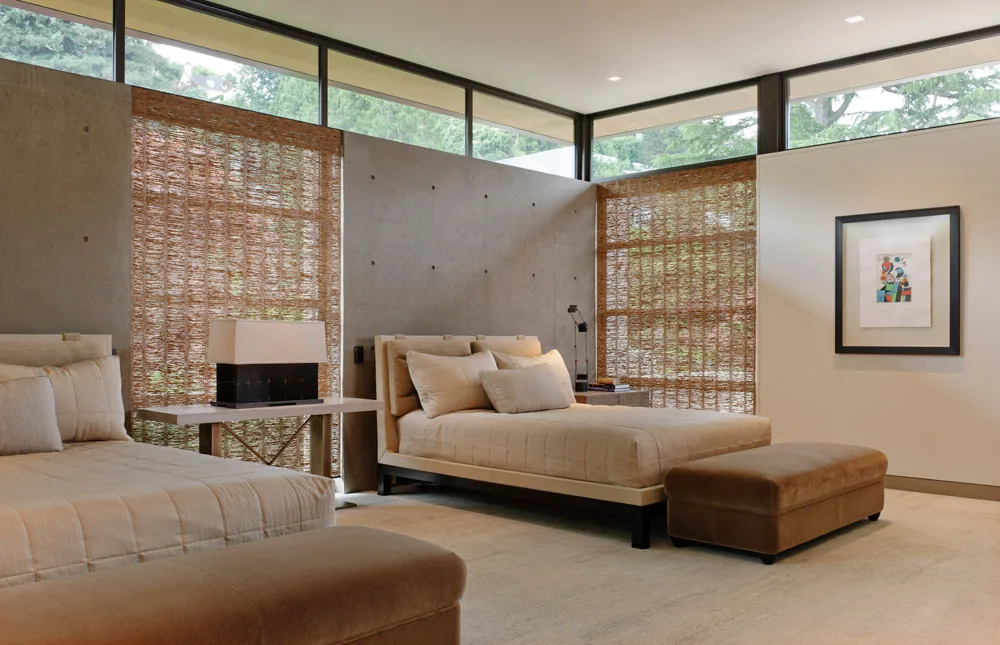 Washington Park Residence bedroom features beige beds with decorative pillows, woven window shades, and clerestory windows providing natural light.