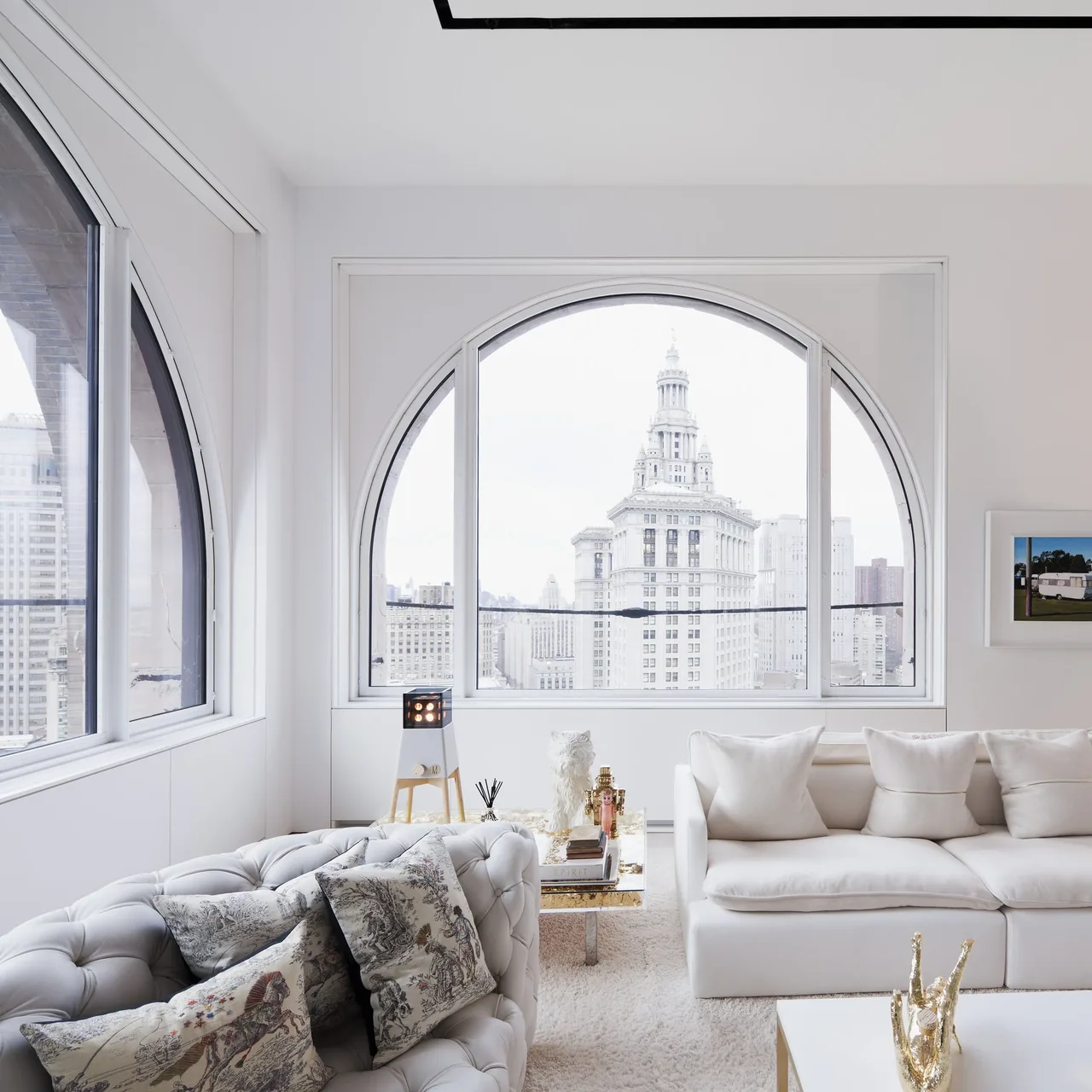 Living room in the Skyhouse project with oval windows and white minimalist design.