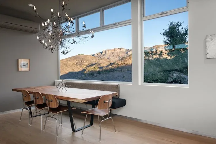 Dining room with large windows framing mountain views in Yerba Buena Residence III.