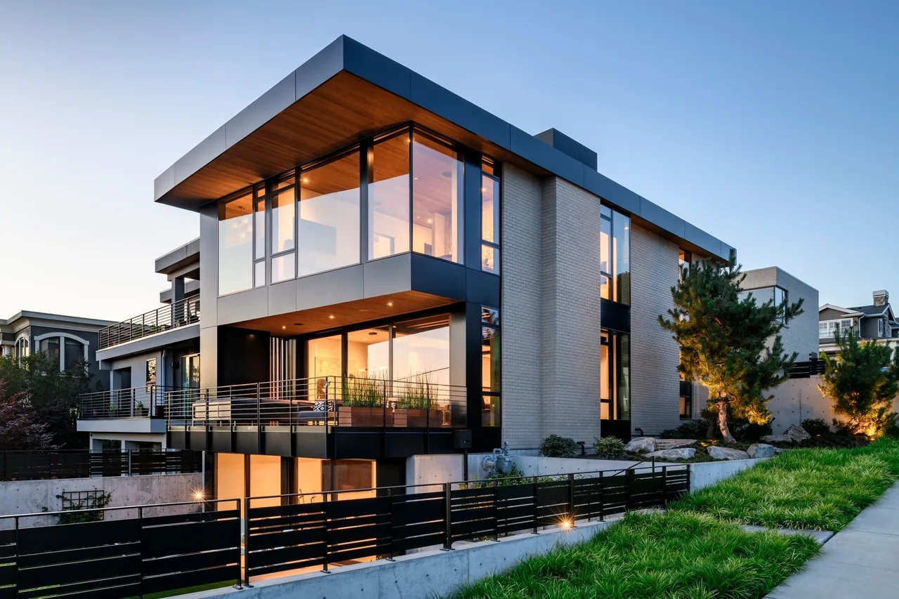 West of Market by Sticklab Architecture features a modern home with extensive glazing, brick walls, and metal trim in Seattle.