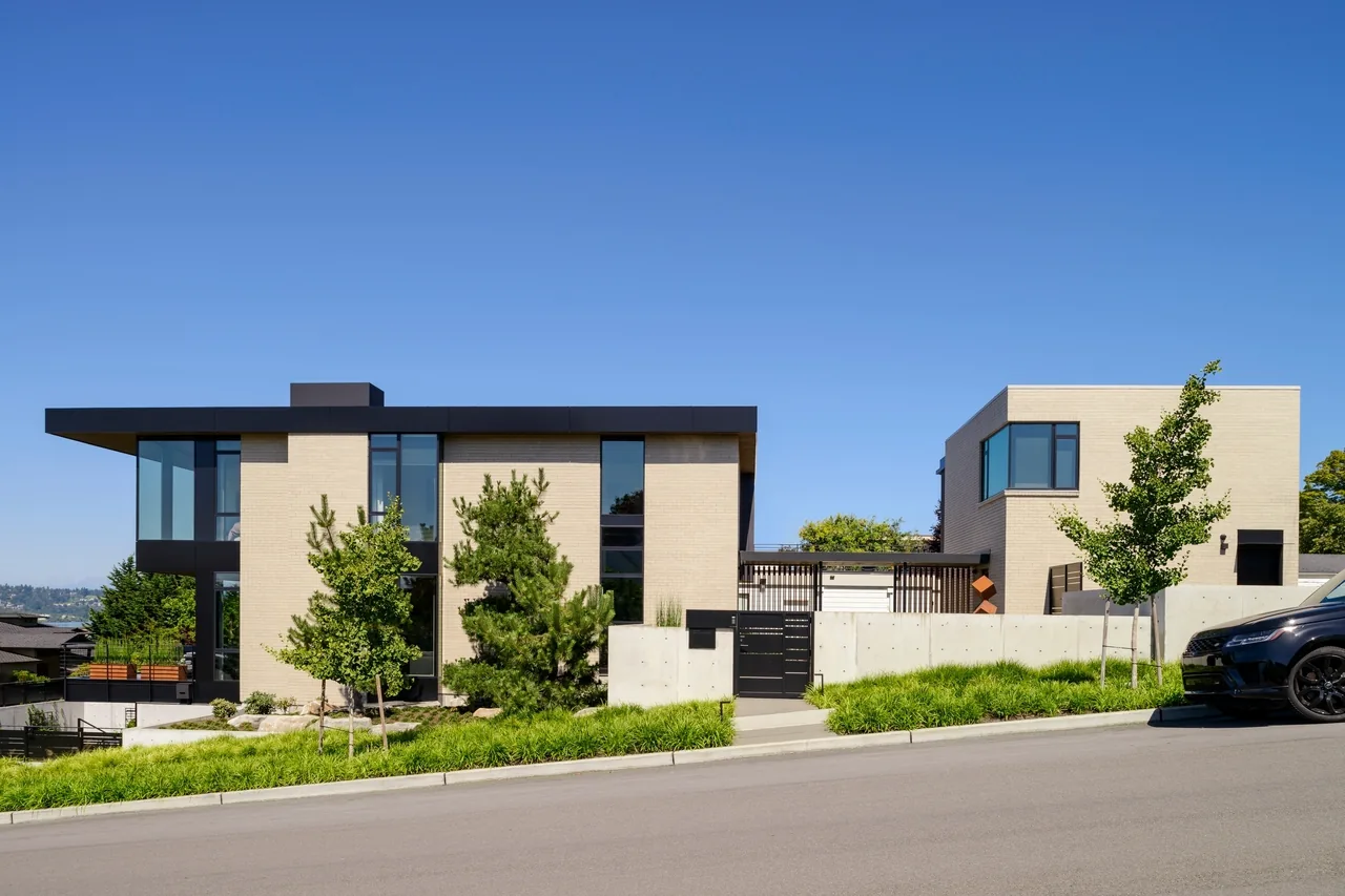 West of Market features a modern two-story brick residence with flat roofs and a concrete retaining wall on a sloped site.