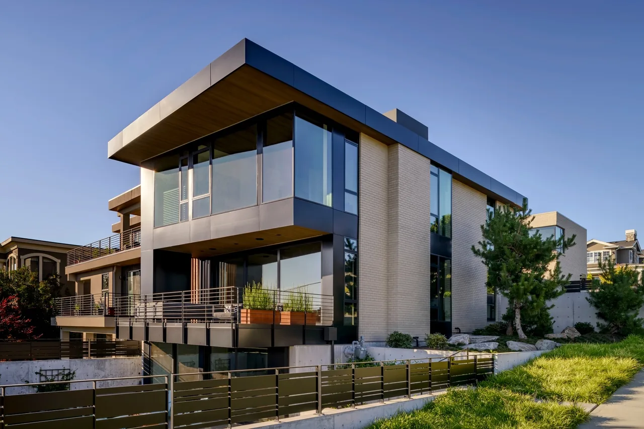 West of Market features large glass windows and metal railings with light brick exterior at sunset.