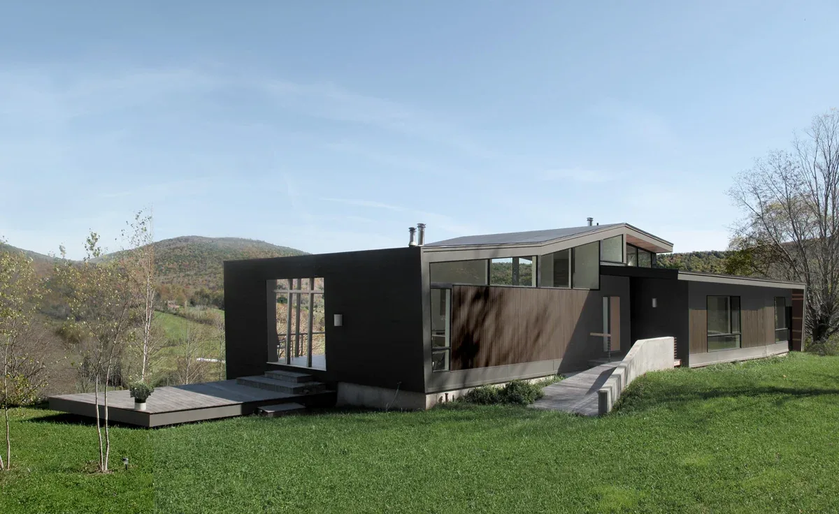 The Quail Ridge House features clean lines with floor-to-ceiling glazing and an expansive deck on a hilltop site.