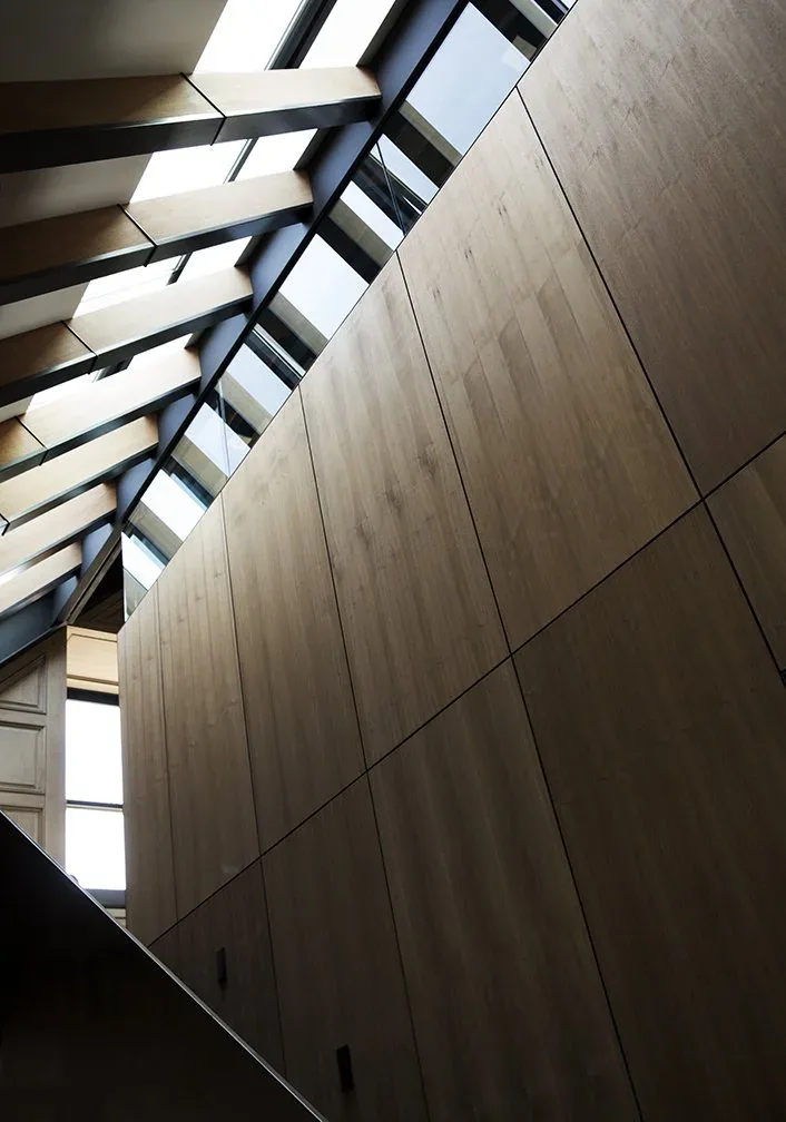 Sloped ceiling features wood paneling and clerestory windows for natural light in Dolores Park project.