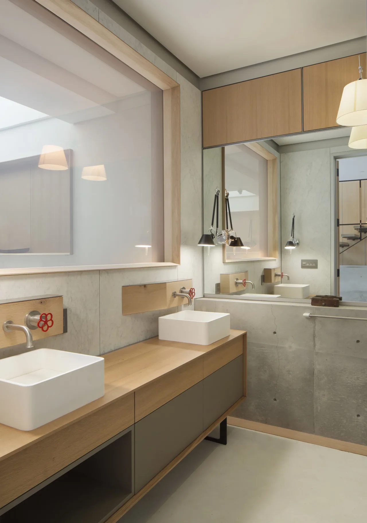 Bathroom features dual rectangular vessel sinks on a wooden vanity with wall-mounted faucets and a large mirror.