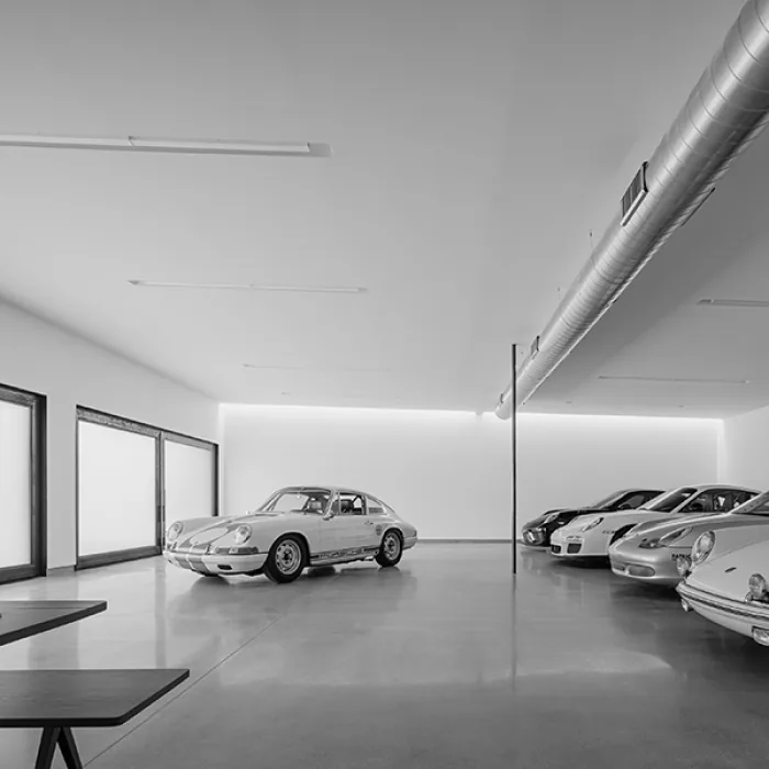 Indoor car storage garage with polished concrete flooring and classic cars.