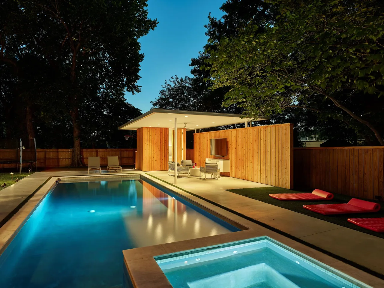 Werner Pool & Pavilion features a modern covered pavilion with a wooden privacy wall and outdoor seating by the pool.