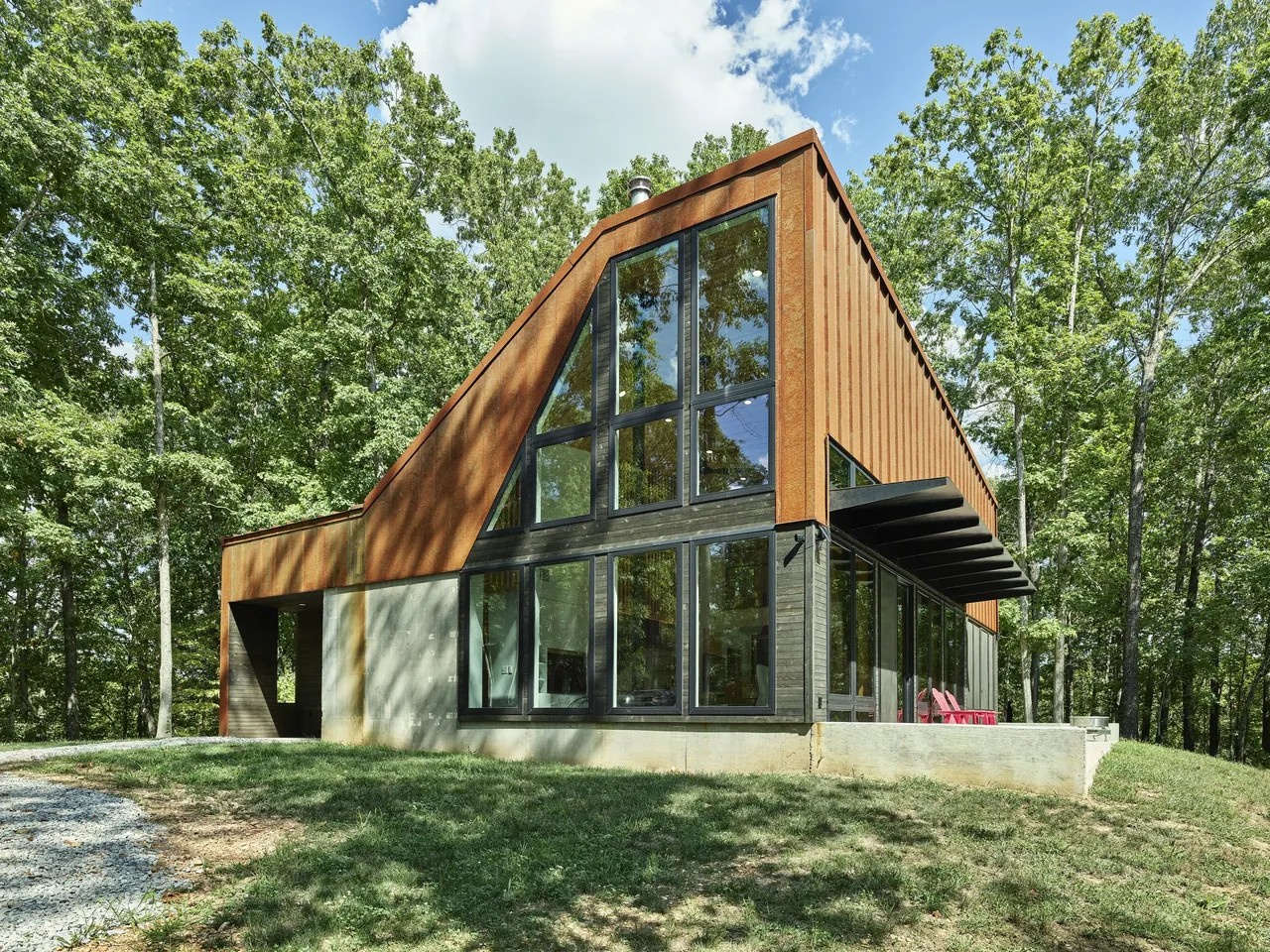 Eclipse Ridge features a rust metal facade with large black window frames and a distinctive sloped roof design.