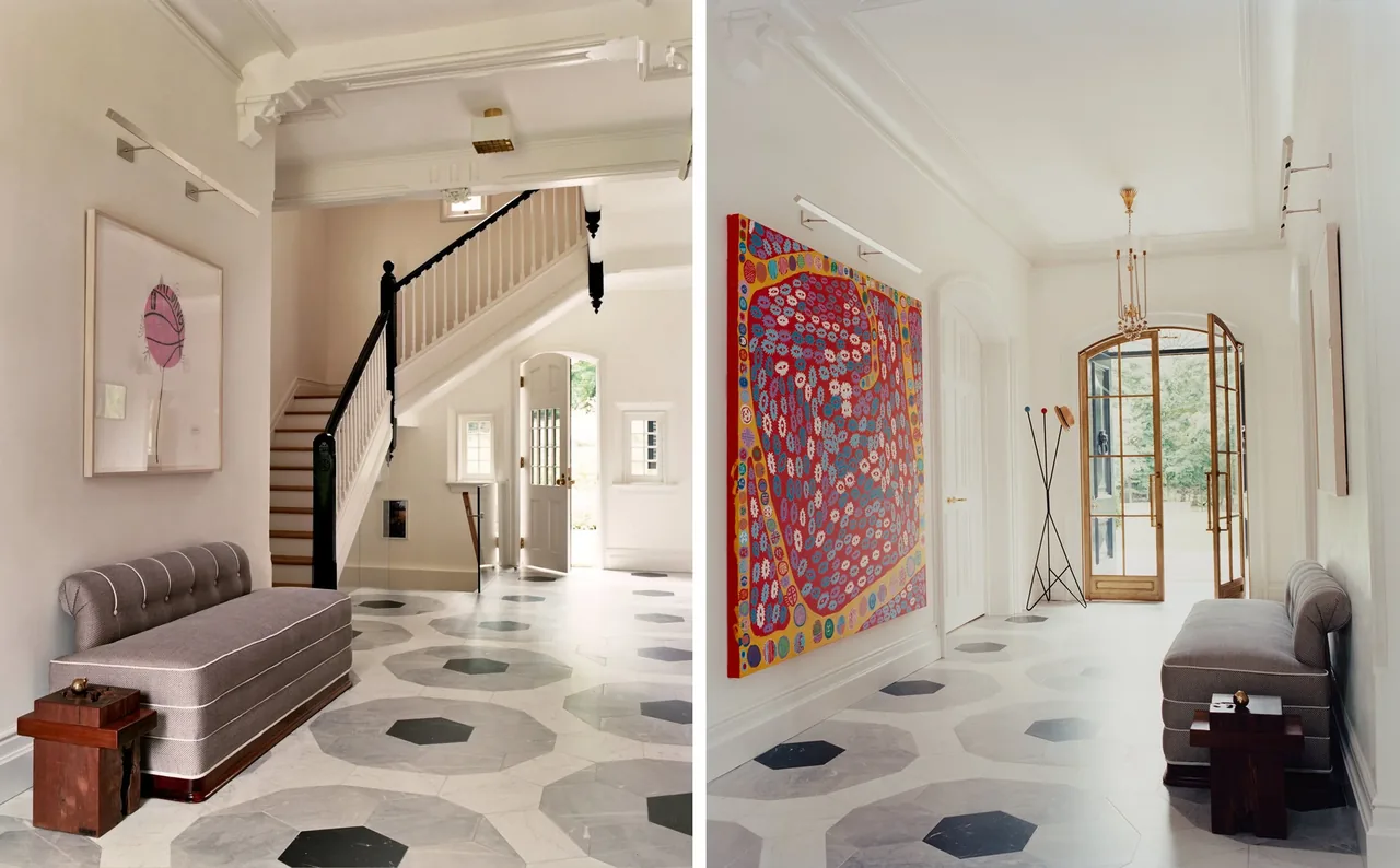 Entryway of Neiderhurst Estate features octagonal tile flooring, a gray upholstered bench, and a stair with contrasting black and white railing.