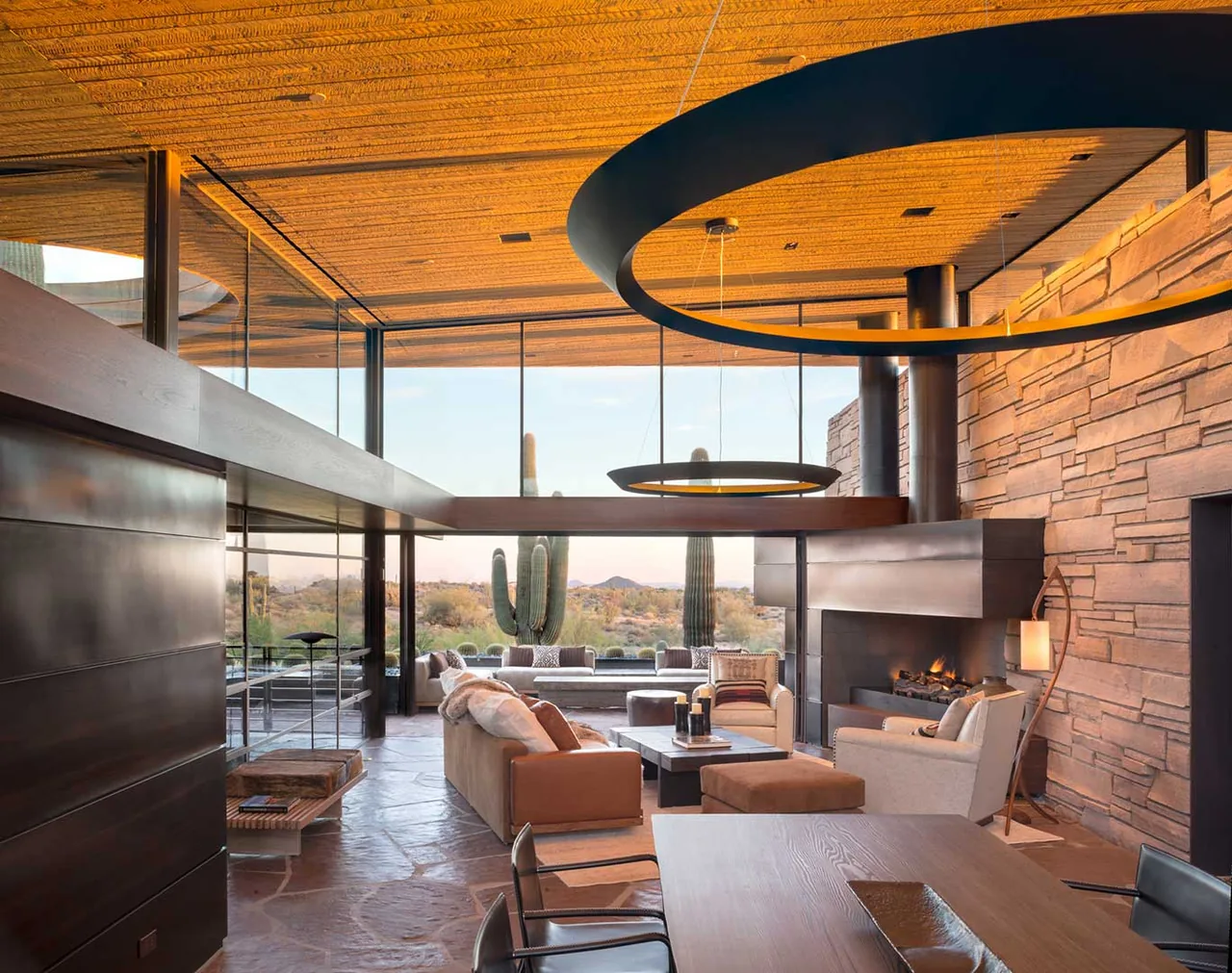 Living room with floor-to-ceiling glazing and desert views at Saguaro Ridge project by Douglas Fredrikson Architects.