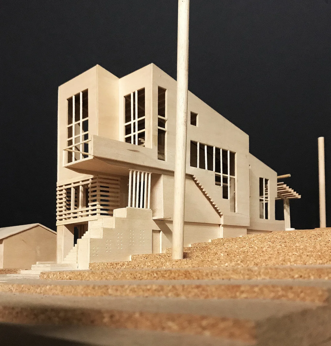 Model of Perch House showing multi-story modern design with vertical window bands and an elevated balcony.