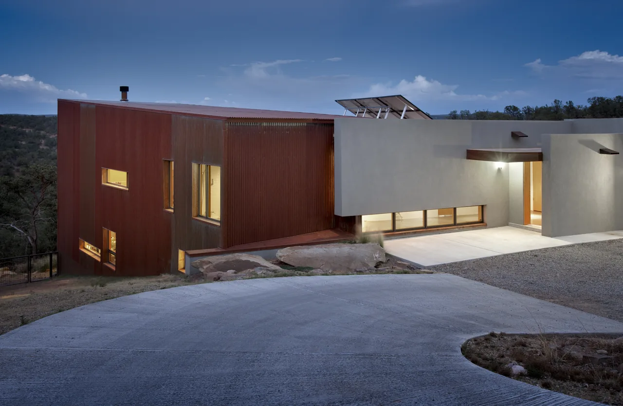 OBLIO HOUSE features a weathered steel exterior volume combined with stucco walls in a modern design by Edward Fitzgerald Architects.