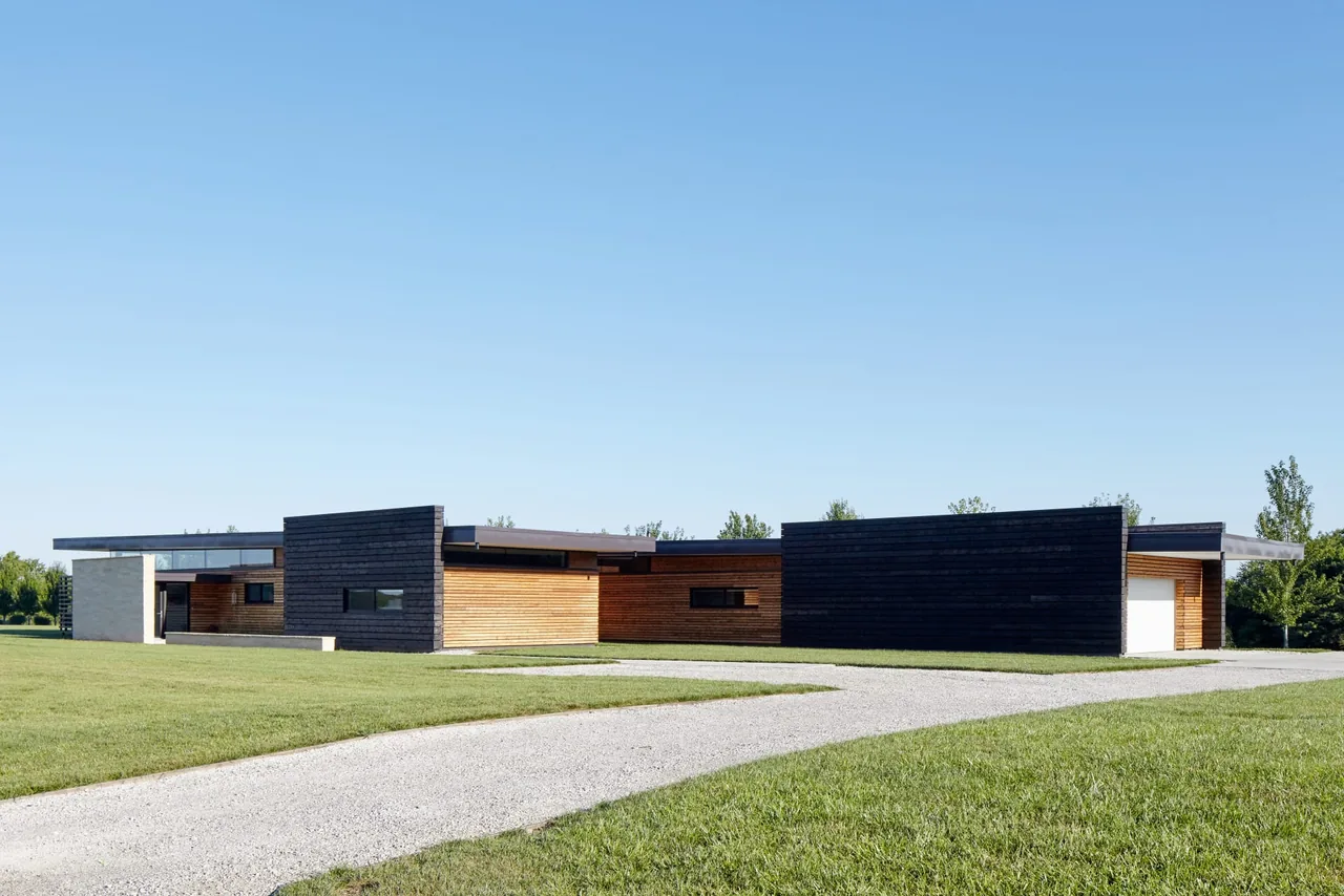 Byers Residence by el dorado inc features a modern flat-roof design with contrasting wood and blackened wood siding.